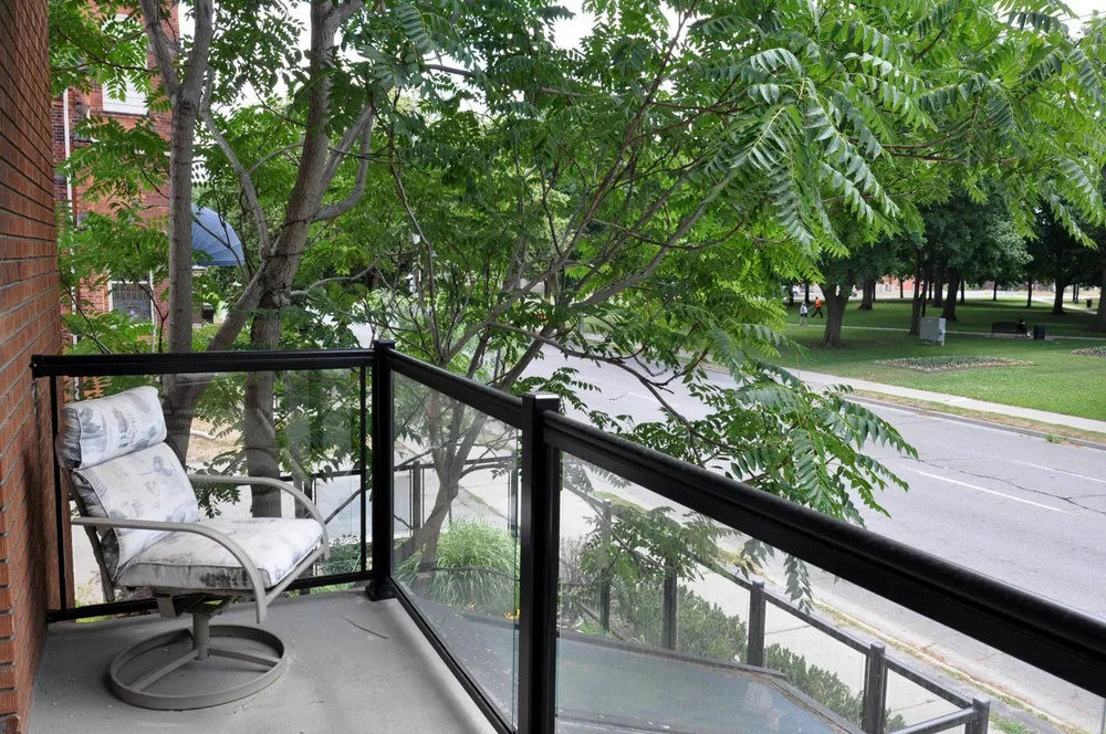 Private suite balcony with a patio chair overlooking Alexandra Park